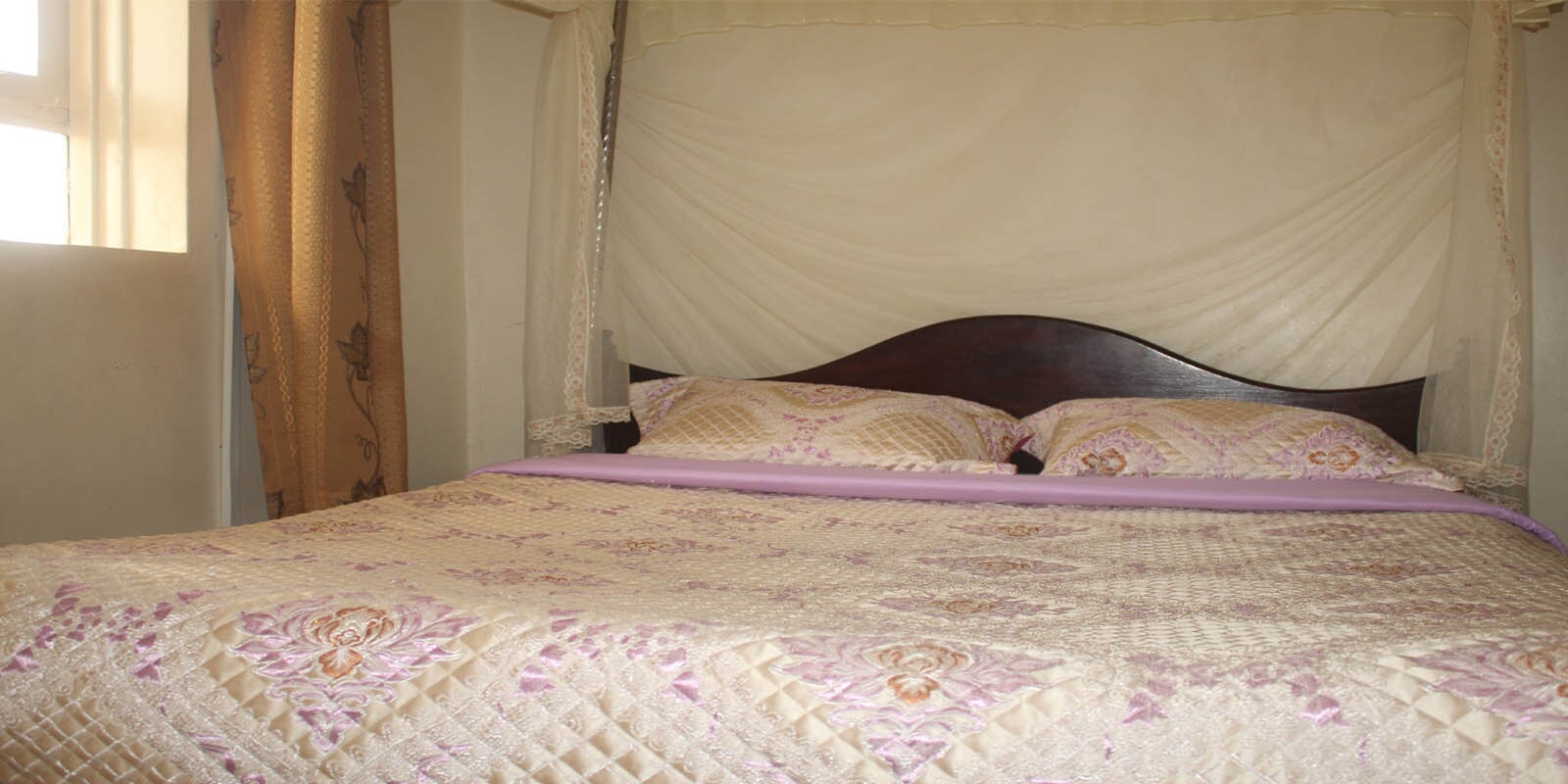 Hotel bedroom with mosquito net