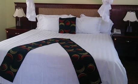 Executive suite bed at Pretoria Hotel Mbale